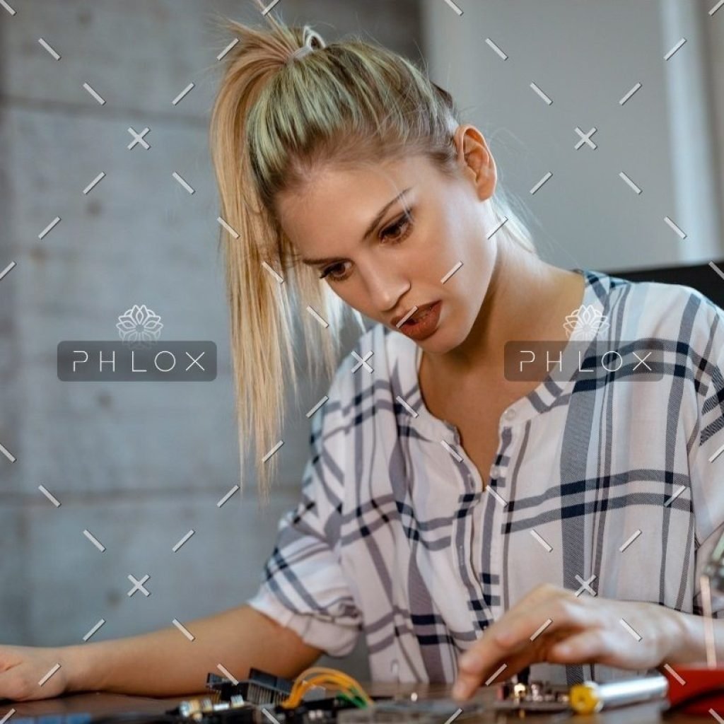 demo-attachment-36-woman-testing-circuit-board-in-her-office-8WM2R6N-croped